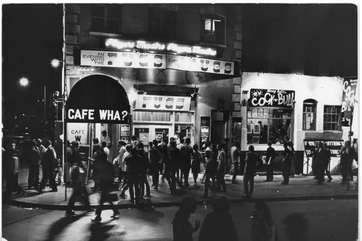 a group of people standing in front of a store