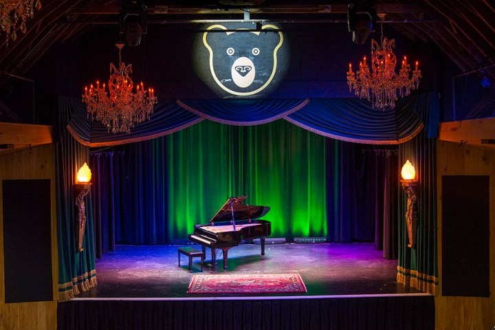 a large room with tables and chairs in a dark room