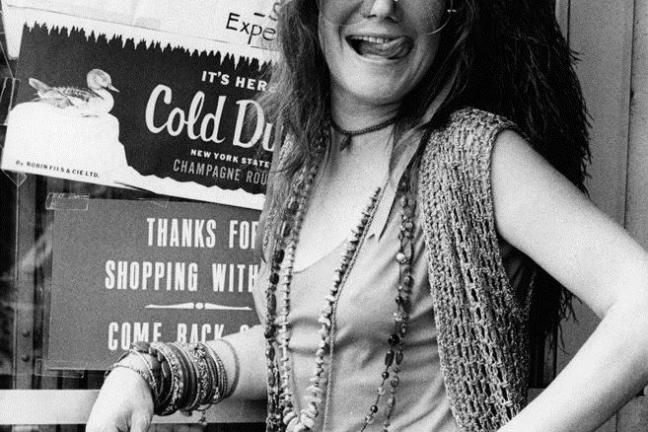 Janis Joplin holding a sign